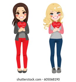 Two cute teenager girls holding red heart with Thank you text