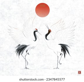 Two dancing crane birds and big red sun on vintage rice paper background. Traditional Japanese ink wash painting sumi-e. Translation of hieroglyph - beauty.