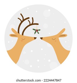 two deer in love under a sprig of mistletoe and snowfall
