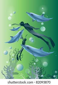two divers playing with four dolphins