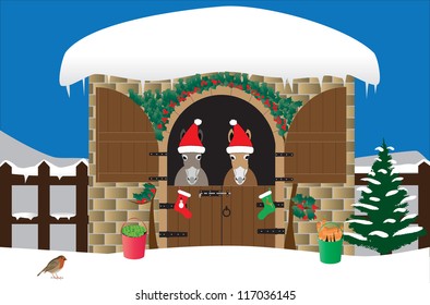 Two Donkeys in Santa Hats in a snow covered stable decorated with holly and a xmas tree,with christmas stockings and buckets of carrots and apples and a robin in the foreground