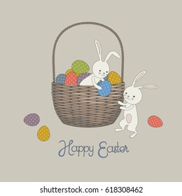Two Easter Bunnies and an Easter basket with colorful painted eggs 