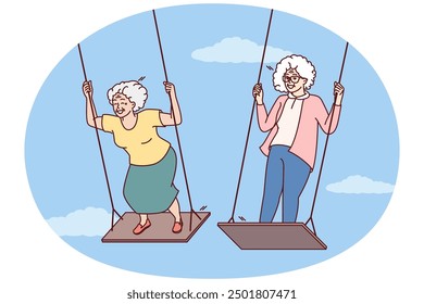 Two elderly women enjoy swinging and enjoying happy old age and not having to go to work. Carefree gray-haired female of retirement age remembers entertainment from youth and does not want to grow old