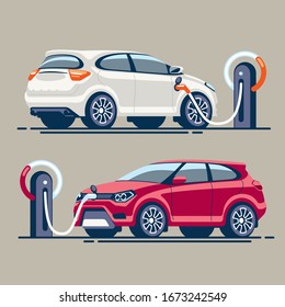 Two electric cars at a gas station are charged with electricity through an electric cable with a connector.