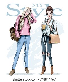 Two fashion girls. Hand drawn stylish beautiful women with bags. Cute set: beautiful young woman with coffee cup and blond hair woman with backpack. Sketch.