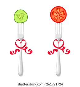 Two forks, tied with red ribbons, with slice of cucumber and tomato, on white background