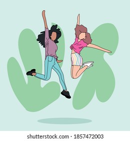 Two friends of different ethnicities jumping against the wall. They are having fun. They are wearing casual clothes