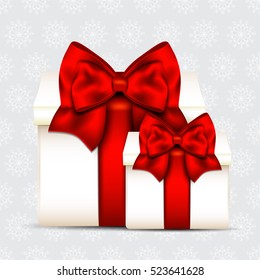 Two gift boxes with red bow isolated on christmas background