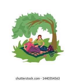 Two girlfriends rest at green city park, picnic