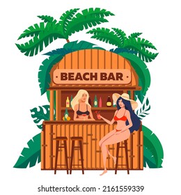 Two girls in a beach bar cocktails surrounded by tropical plants.