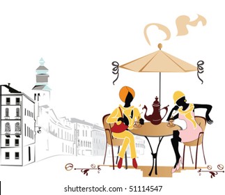 Two girls drinking coffee in a open-air cafe