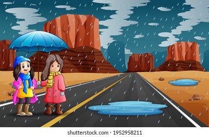 Two girls holding umbrella in the rain