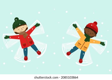 Two girls laying down making snow angels. Winter holidays. Playing outdoors. Christmas season.