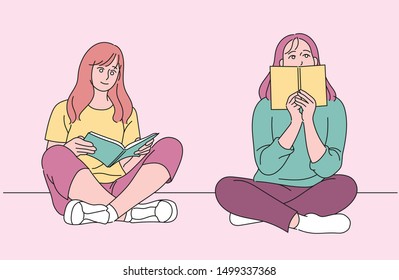Two girls are reading a book sitting on the floor. hand drawn style vector design illustrations.