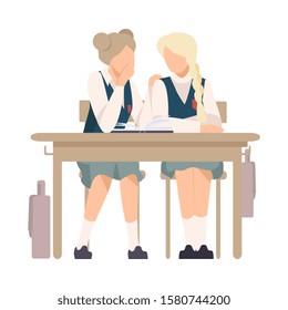 Two Girls Sitting At School Desk and Gossiping Vector Illustration