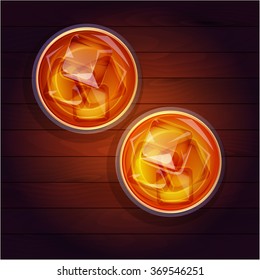 Two glasses of whiskey with ice on a wooden table, top view