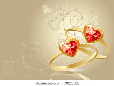 Two gold rings with gems on beige background