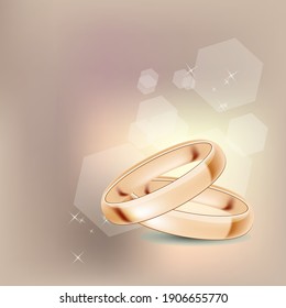 Two golden rings on beige background