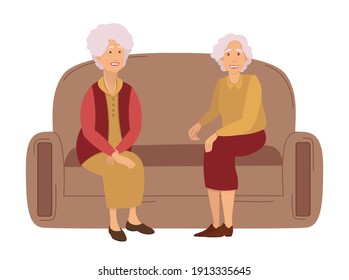 Two grandmothers on a meeting at home sitting on the sofa communicating, isolated on white. Friendship of old people. Old Girlfriends. Older woman talking together. Old women discuss retirement