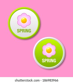 Two green spring icons or badges isolated on pink background