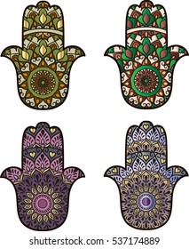 Two green and two violet hamsa on a white background