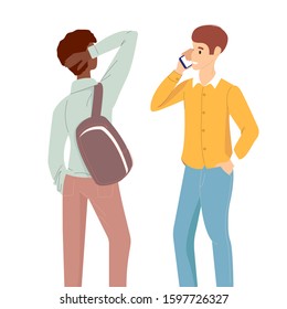 Two guys talk different races. The young man speaks on the phone, a friend is standing nearby. Concept: communication of international students, conversations of friends, exchange student.