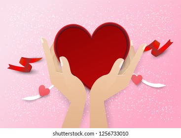 two hand hold red heart gift box with red ribbon on pink background,valentine,love.wedding.