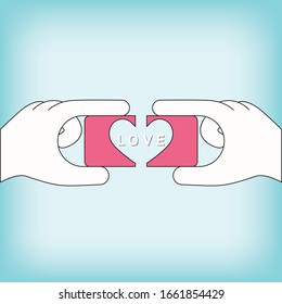 Two hand holding two a piece jigsaw in shape of a heart, symbol of the love.