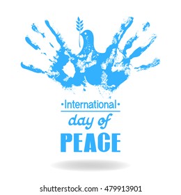 Two hand prints made a silhouette of a flying dove of peace with an olive branch. Concept for International peace day.