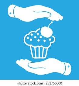 two hands with badge with white cake icon and cherry on a blue background - vector illustration