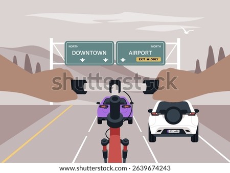 Two hands gripping a bike's handlebars head north on the highway, Cars occupy the lanes in front of the cyclist, with signs indicating directions to Downtown and the Airport