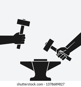 Two hands with hammers above anvil