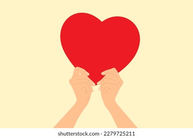 Two hands holding a big red heart. Concept of love, charity, donation. 