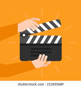 Two hands holding a cinema clapper in flat style - movie concept