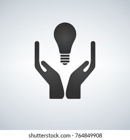 Two hands holding light bulb, black flat icon isolated on light background