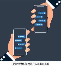 Two hands holding phones and communicate with each other by voice messages.