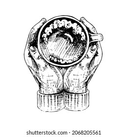Two hands hugging a cup of coffee. Top view. Vintage vector hatching black hand drawn illustration isolated on white background