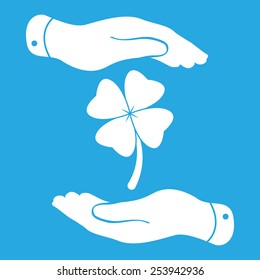 two hands protecting clover with four leaves sign icon. on a blue background. Saint Patrick symbol