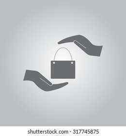 Two hands protecting or giving a shopping bag