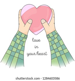 two hands of a woman holding a heart