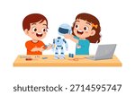 Two happy children smiling and building a robot on a desk with tools and a laptop