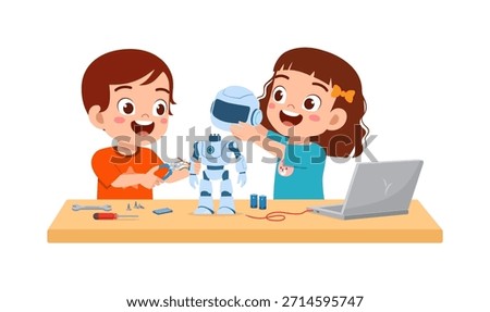Two happy children smiling and building a robot on a desk with tools and a laptop