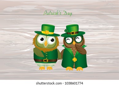 Two happy owls in national costume at Patrick's Day holding hands. Greeting card with owlet. Free space for your ad or text. Vector illustration on wooden background.