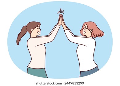 Two happy women rejoice high five greet each other after long-awaited meeting. Positive girls in casual clothes are happy to know about next vacation and joint summer trip