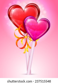 Two heart lollipops of different colors on bright background