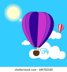two hot air balloons fly over the clouds on a blue sky during a clear sunny day