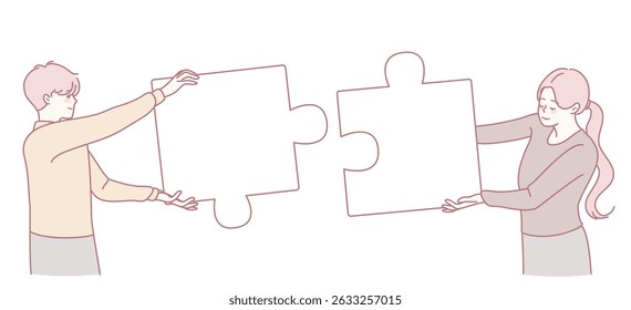 Two individuals are actively joining puzzle pieces together, representing teamwork, connection, and unity