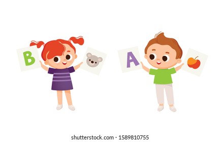 Two Kids, boy and girl holds leanning flashcards. Kids with english flashcards. Cards with letters. Learning English.