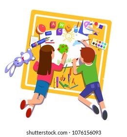 Two kids boy & girl paint & draw one picture on paper using pencils, markers & paintbrush laying with toys on carpet. Top view. Flat style character vector illustration isolated on white background Two kids boy & girl paint & draw one picture on paper using pencils, markers & paintbrush laying with toys on carpet. Top view. Flat style character vector illustration isolated on white background
