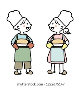 Two kids holding a tray of freshly baked bread and smiling to each other. Little girl and little boy with aprons carrying trays of homemade breads. Little chefs with chef hats presenting their breads.